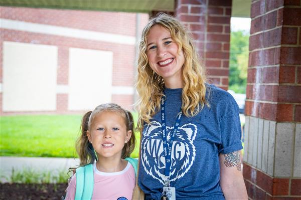 mom and girl student smiling